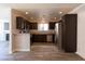 Modern kitchen with stainless steel appliances, dark cabinets, and stylish gray flooring at 5461 Dungaree St, Las Vegas, NV 89118