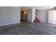 Spacious living room featuring gray flooring, stairs to the upper level, and a chandelier-lit dining area at 5461 Dungaree St, Las Vegas, NV 89118