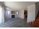 Open-concept living room with sleek gray floors, fireplace, and stairs leading to the upper level at 5461 Dungaree St, Las Vegas, NV 89118