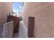 Side yard view featuring stucco walls and walkway at 5461 Dungaree St, Las Vegas, NV 89118