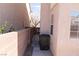 Narrow side yard with trash can, concrete walkway, and block wall at 5461 Dungaree St, Las Vegas, NV 89118