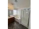 Bright bathroom featuring double sinks, a soaking tub, and a glass-enclosed shower at 5661 Bonds Flat St, Las Vegas, NV 89148