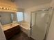 Bright bathroom showing a large vanity, a soaking tub, and a glass enclosed shower at 5661 Bonds Flat St, Las Vegas, NV 89148