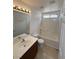 Bathroom featuring a single sink vanity, toilet, and shower-tub combination at 5661 Bonds Flat St, Las Vegas, NV 89148