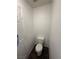 Cozy powder room showing a toilet, dark flooring, and white walls at 5661 Bonds Flat St, Las Vegas, NV 89148