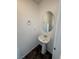 A powder room features a pedestal sink and a decorative mirror, providing a functional space at 5661 Bonds Flat St, Las Vegas, NV 89148