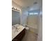 Functional bathroom showing a single vanity, a combined tub and shower, and neutral colors at 5661 Bonds Flat St, Las Vegas, NV 89148