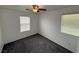 Bedroom with gray carpeting, two windows with blinds at 5661 Bonds Flat St, Las Vegas, NV 89148