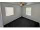 Bedroom with gray carpet, a ceiling fan, and two windows at 5661 Bonds Flat St, Las Vegas, NV 89148