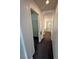 Hallway view showing a walk-in closet, and a bathroom with walk-in shower and tub at 5661 Bonds Flat St, Las Vegas, NV 89148