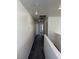 Upstairs hallway view with gray carpet and white walls leading to bedrooms at 5661 Bonds Flat St, Las Vegas, NV 89148