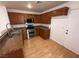 Kitchen with granite countertops, stainless steel appliances, and dark wood cabinets at 5661 Bonds Flat St, Las Vegas, NV 89148