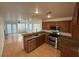 Kitchen view with laminate flooring, granite countertops, and living room in the background at 5661 Bonds Flat St, Las Vegas, NV 89148