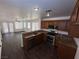 Open kitchen with granite countertops, stainless steel appliances, and dark wood flooring at 5661 Bonds Flat St, Las Vegas, NV 89148