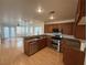 Well-equipped kitchen features stainless steel appliances, granite countertops, and dark wood cabinets at 5661 Bonds Flat St, Las Vegas, NV 89148