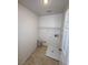 Small laundry area with washer hookups and a utility sink on the floor at 5661 Bonds Flat St, Las Vegas, NV 89148
