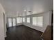 Spacious living room with dark flooring and a seamless flow into the adjacent kitchen at 5661 Bonds Flat St, Las Vegas, NV 89148