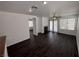 Spacious living room with dark wood floors, a fireplace, and natural light from the windows and glass doors at 5661 Bonds Flat St, Las Vegas, NV 89148