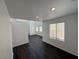Open-concept living area with dark floors, light walls, and abundant natural light at 5661 Bonds Flat St, Las Vegas, NV 89148