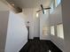 Airy living room featuring high ceilings, ample natural light, and sleek dark floors at 5661 Bonds Flat St, Las Vegas, NV 89148