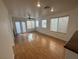 Living room with a fan, windows, curtains, and laminate floors at 5661 Bonds Flat St, Las Vegas, NV 89148