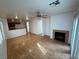 Open living room with hardwood floors and a fireplace, flowing into the kitchen area at 5661 Bonds Flat St, Las Vegas, NV 89148