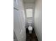 Bathroom stall featuring a standard toilet, wood-look floor, and white walls at 5661 Bonds Flat St, Las Vegas, NV 89148