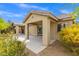 Exterior view of covered patio with stone columns and lush backyard landscaping at 5912 Cuddles Ct, North Las Vegas, NV 89081