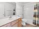 Bright bathroom featuring a single sink vanity, toilet, and a shower-tub combination at 5912 Cuddles Ct, North Las Vegas, NV 89081