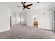 Spacious bedroom with neutral carpet, ceiling fan, and access to the en-suite bathroom at 5912 Cuddles Ct, North Las Vegas, NV 89081