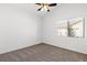 Bright bedroom featuring carpet floors, a ceiling fan, and a window with neighborhood views at 5912 Cuddles Ct, North Las Vegas, NV 89081