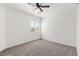 Cozy bedroom with carpet flooring, a ceiling fan, and a window overlooking the neighborhood at 5912 Cuddles Ct, North Las Vegas, NV 89081