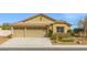 Inviting single-story home featuring a three-car garage and low maintenance desert landscaping at 5912 Cuddles Ct, North Las Vegas, NV 89081