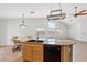 Spacious kitchen island features granite countertops, black appliances, and tile flooring at 5912 Cuddles Ct, North Las Vegas, NV 89081