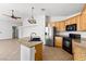 Bright kitchen featuring granite countertops, stainless steel appliances, and wood cabinetry at 5912 Cuddles Ct, North Las Vegas, NV 89081