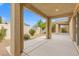 Spacious covered patio with concrete flooring and backyard view, with white fence at 5912 Cuddles Ct, North Las Vegas, NV 89081