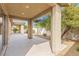 Covered patio area with concrete flooring, view of backyard landscaping and beautiful columns at 5912 Cuddles Ct, North Las Vegas, NV 89081