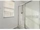 Bathroom featuring a glass-enclosed shower and a window with privacy blinds at 6382 Lonesome Lake St, Las Vegas, NV 89148