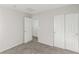 Neutral bedroom with sliding closet doors and access to another room at 6382 Lonesome Lake St, Las Vegas, NV 89148