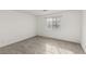 Bright empty bedroom with a window and neutral colored carpet at 6382 Lonesome Lake St, Las Vegas, NV 89148