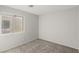 Neutral bedroom featuring neutral walls, carpet and a window for natural light at 6382 Lonesome Lake St, Las Vegas, NV 89148