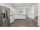 Bright eat-in kitchen with white appliances, grey floors, and stairs to the right at 6382 Lonesome Lake St, Las Vegas, NV 89148