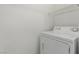 Close-up of a white top-load washing machine with a wire shelf above at 6382 Lonesome Lake St, Las Vegas, NV 89148