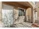 Covered front porch, with white columns and seating area at 6382 Lonesome Lake St, Las Vegas, NV 89148
