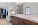 Spacious bathroom featuring double sinks, large mirror, and walk-in closet at 6447 Wide Sky St, Las Vegas, NV 89166