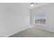 Bright bedroom with neutral carpet, ceiling fan, and a window with mountain views at 6447 Wide Sky St, Las Vegas, NV 89166