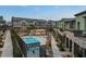 Exterior view of townhomes with a community pool and jacuzzi at 6447 Wide Sky St, Las Vegas, NV 89166
