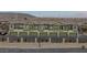 Exterior view of townhomes featuring garages, and manicured landscaping at 6447 Wide Sky St, Las Vegas, NV 89166