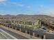 Exterior view of townhomes with garages, sidewalks, and desert landscaping at 6447 Wide Sky St, Las Vegas, NV 89166
