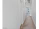 Neutral hallway featuring carpet, white walls, and a glimpse of the balcony view at 6447 Wide Sky St, Las Vegas, NV 89166